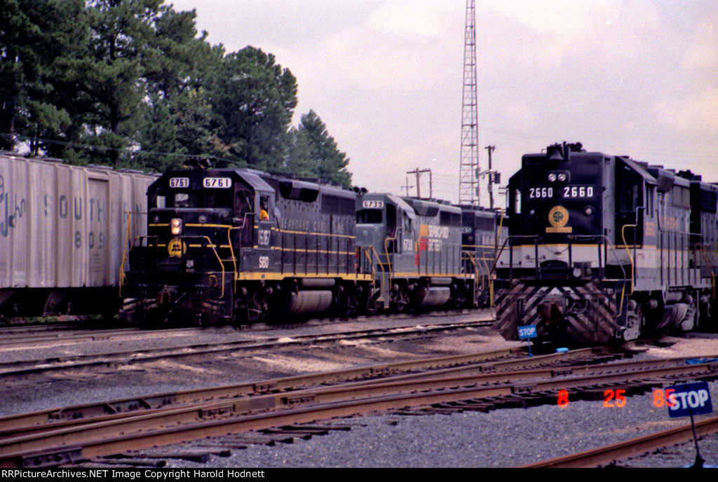 SOU 2660 sits in the yard as a string of "foreign power" rolls by